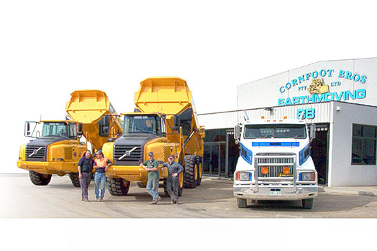 Volvo dump trucks and tip truck out front of Cornfoot Bros yard
